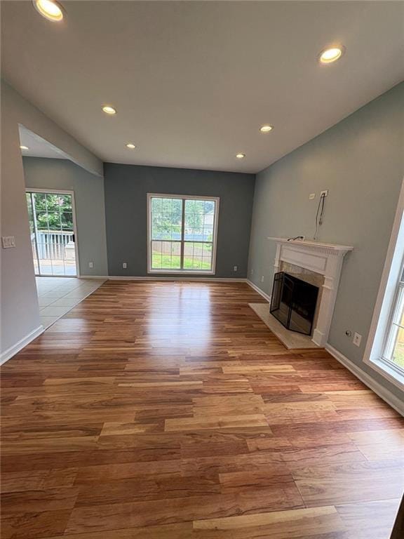 1951 Bergerac Ct SW, Marietta, GA 30008 - unfurnished living room with plenty of natural light, wood finished floors, recessed lighting, a fireplace, and baseboards