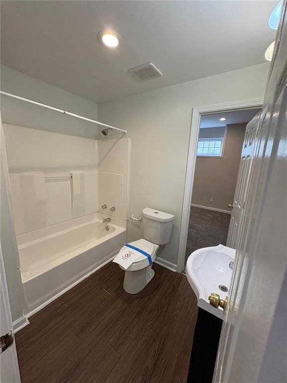 1951 Bergerac Ct SW, Marietta, GA 30008 - full bathroom with vanity, shower / bath combination, wood finished floors, toilet, and baseboards