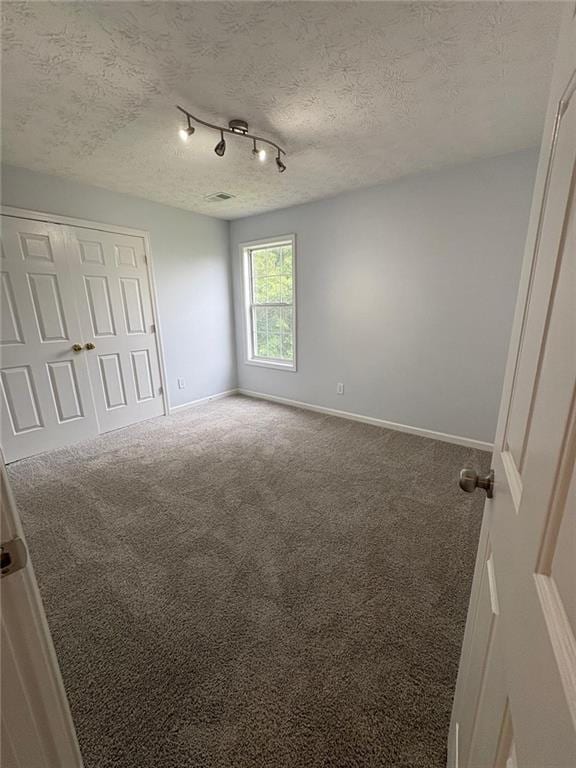 1951 Bergerac Ct SW, Marietta, GA 30008 - unfurnished bedroom with carpet, baseboards, a closet, and a textured ceiling