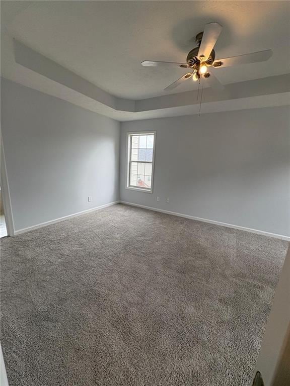 1951 Bergerac Ct SW, Marietta, GA 30008 - carpeted spare room with a ceiling fan, baseboards, and a raised ceiling