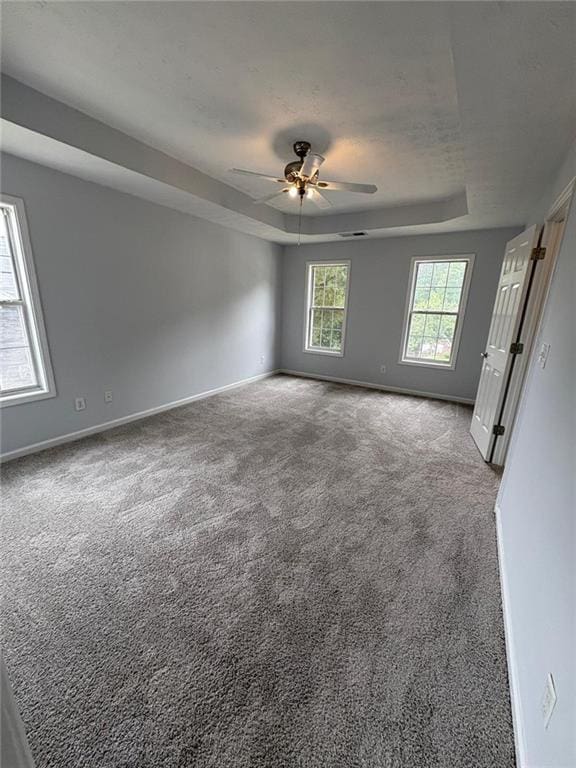 1951 Bergerac Ct SW, Marietta, GA 30008 - spare room with a tray ceiling, ceiling fan, baseboards, and carpet