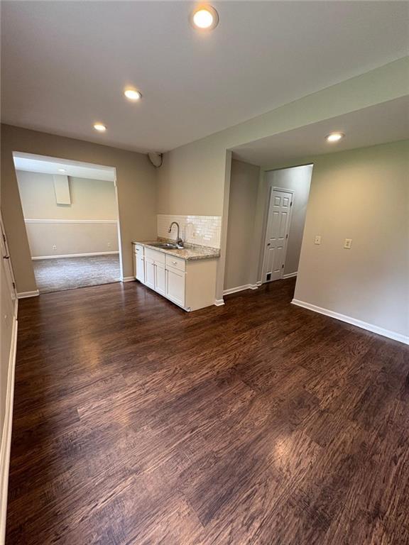 1951 Bergerac Ct SW, Marietta, GA 30008 - empty room featuring a sink, baseboards, recessed lighting, and dark wood-style floors