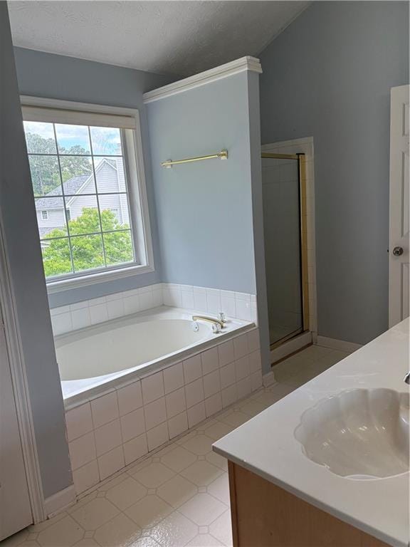 bathroom featuring a stall shower, a bath, and vanity