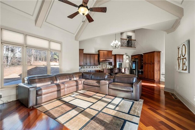 living room with dark wood-style floors, high vaulted ceiling, baseboards, and ceiling fan with notable chandelier