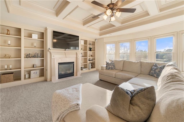 living room featuring a high end fireplace, a wealth of natural light, coffered ceiling, and carpet flooring