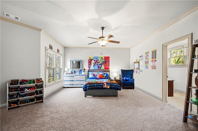 carpeted bedroom featuring baseboards, visible vents, ceiling fan, and crown molding