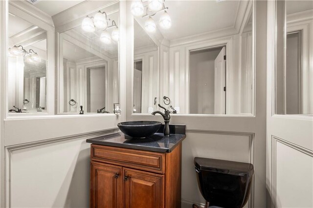 bathroom featuring ornamental molding and vanity