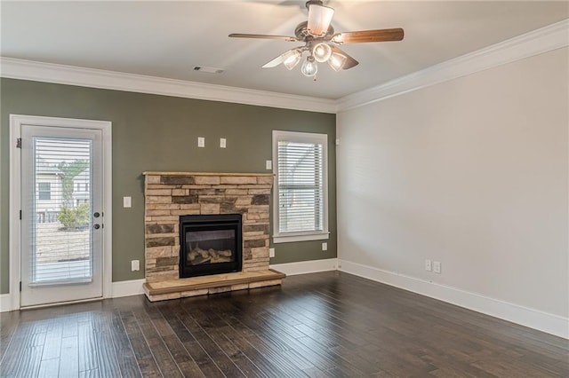 unfurnished living room with dark hardwood / wood-style flooring, a stone fireplace, and crown molding