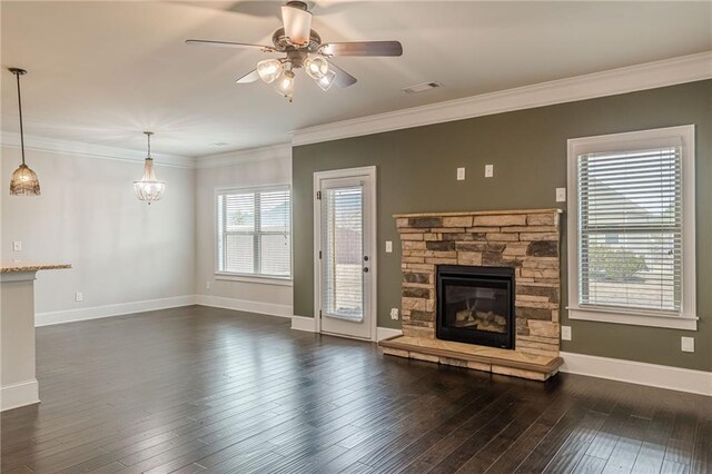 unfurnished living room with a fireplace, dark wood-type flooring, ornamental molding, and ceiling fan