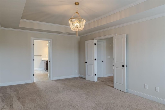 unfurnished bedroom featuring light carpet, ornamental molding, a raised ceiling, and a chandelier