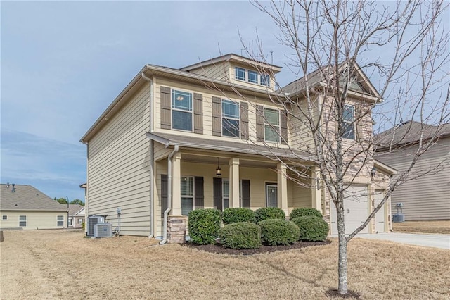 view of front of property with a garage, central AC, covered porch, and a front lawn