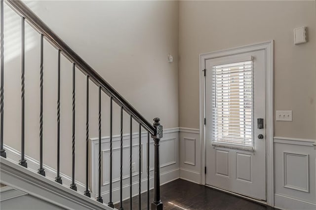146 Blackgum Trce, Dallas, GA 30132 - foyer featuring a wainscoted wall, dark wood-type flooring, stairway, and a decorative wall