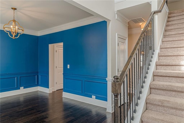 146 Blackgum Trce, Dallas, GA 30132 - stairs featuring wood finished floors, visible vents, a decorative wall, crown molding, and a chandelier