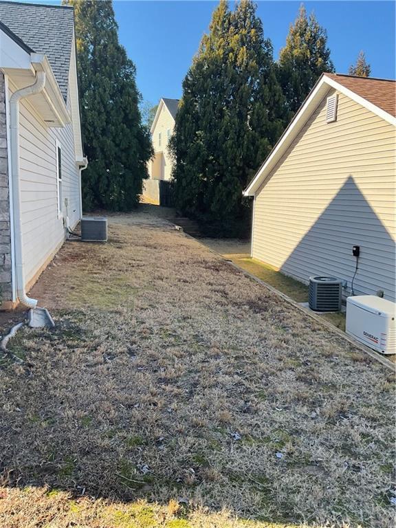 view of yard featuring central air condition unit