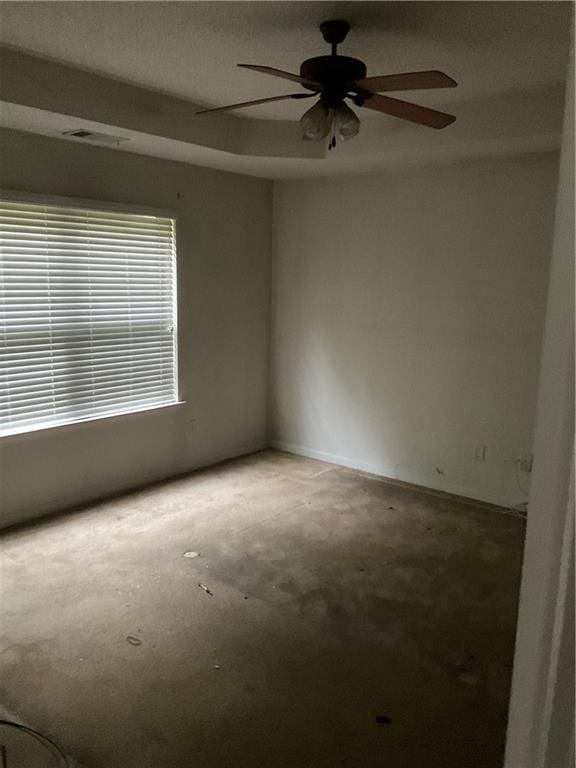 unfurnished room featuring visible vents and ceiling fan