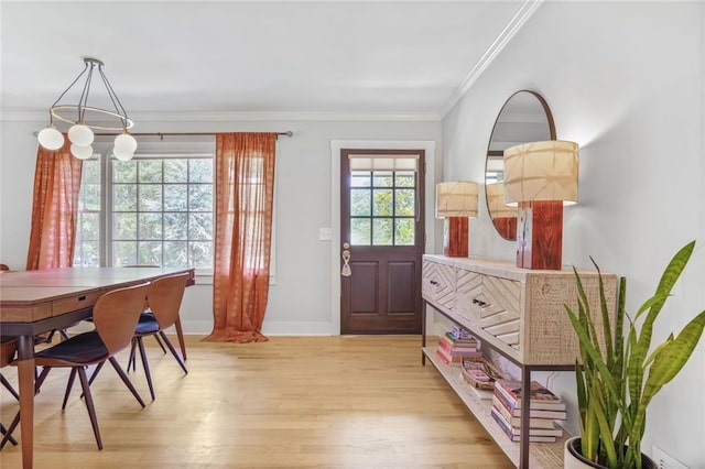 entryway featuring light wood-type flooring, ornamental molding, and baseboards