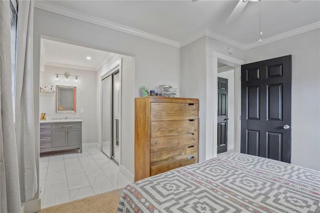bedroom with light marble finish floors, crown molding, baseboards, ensuite bath, and ceiling fan