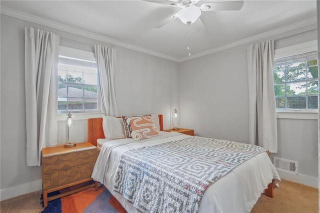 carpeted bedroom featuring multiple windows, baseboards, ornamental molding, and ceiling fan