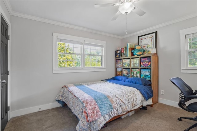 carpeted bedroom featuring ornamental molding, baseboards, ceiling fan, and an office area