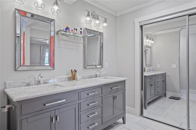 full bath with double vanity, ornamental molding, baseboards, and marble finish floors
