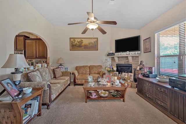 living room featuring ceiling fan, light colored carpet, and vaulted ceiling