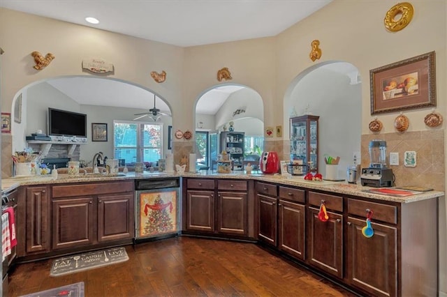 kitchen featuring light stone countertops, dishwasher, dark brown cabinets, dark hardwood / wood-style flooring, and kitchen peninsula