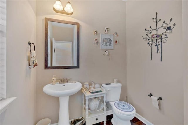 bathroom featuring toilet and sink