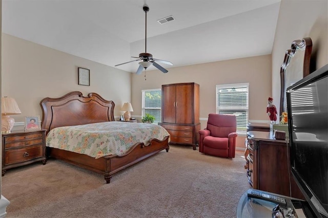 carpeted bedroom featuring ceiling fan, vaulted ceiling, and multiple windows