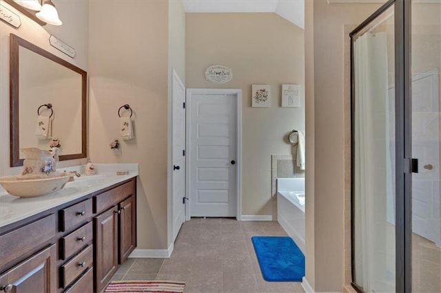 bathroom with vanity, independent shower and bath, vaulted ceiling, and tile patterned flooring