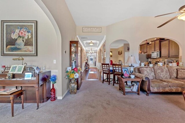 carpeted living room featuring lofted ceiling and ceiling fan