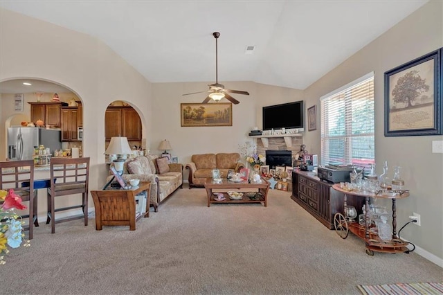 carpeted living room with vaulted ceiling and ceiling fan