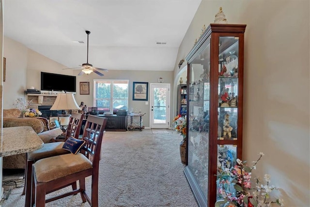 living room featuring lofted ceiling, carpet floors, and ceiling fan