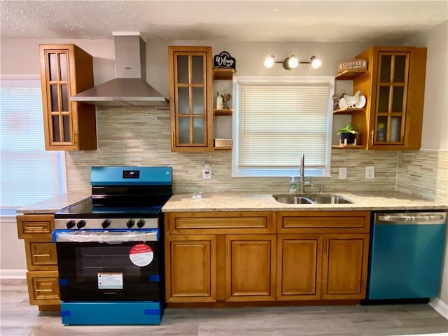 kitchen with dishwasher, backsplash, wall chimney range hood, sink, and range