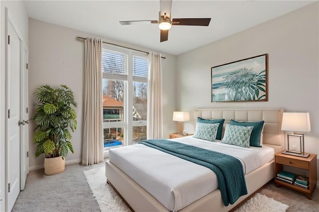 bedroom featuring ceiling fan and light carpet