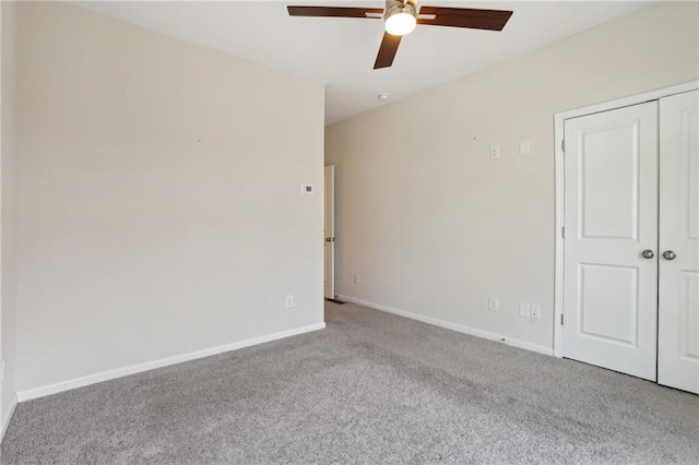 unfurnished bedroom featuring ceiling fan, a closet, and light carpet