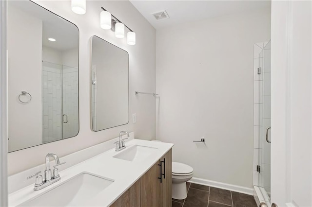 bathroom with tile patterned flooring, toilet, walk in shower, and vanity