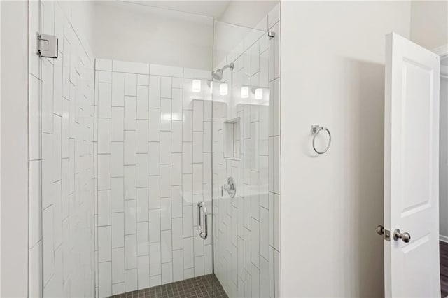 bathroom featuring a shower with door