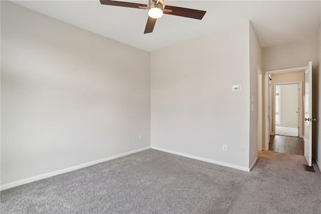 empty room with ceiling fan and light colored carpet