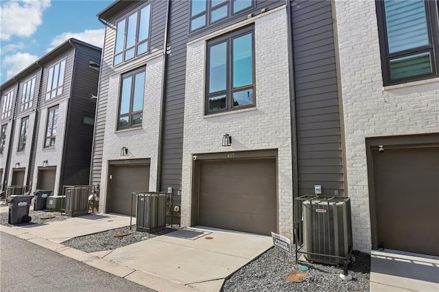 exterior space with a garage and central air condition unit