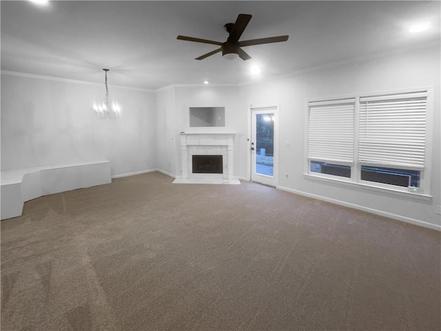 unfurnished living room with baseboards, a fireplace with flush hearth, carpet floors, and crown molding