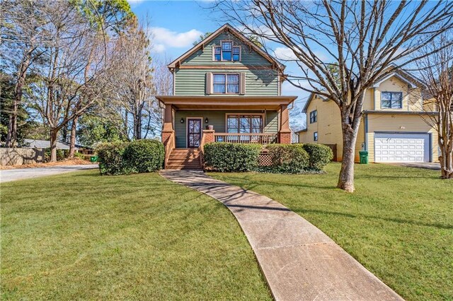 view of front of property with a garage, a porch, a front yard, and brick siding