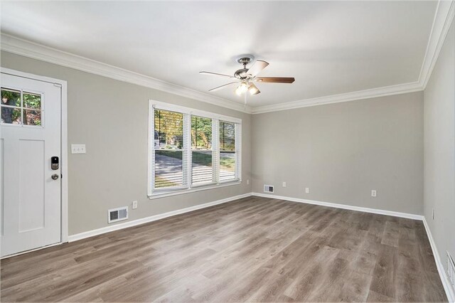 2434 Miriam Ln, Decatur, GA 30032 - unfurnished room with visible vents, ornamental molding, ceiling fan, and wood finished floors