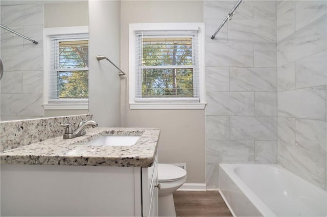 2434 Miriam Ln, Decatur, GA 30032 - bathroom featuring vanity, toilet, wood finished floors, and tub / shower combination