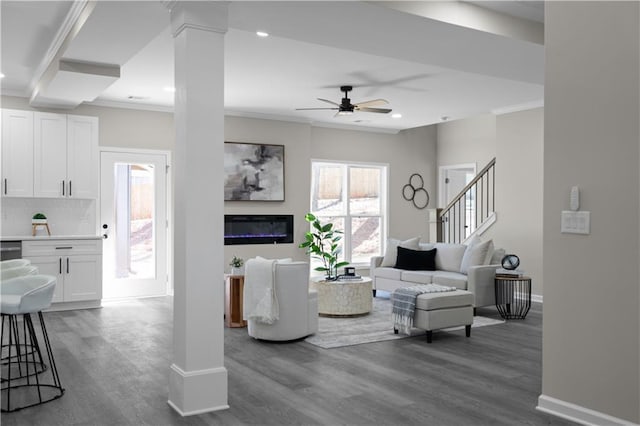 living room with ceiling fan, baseboards, dark wood finished floors, and crown molding