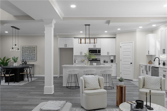 living room with baseboards, ornamental molding, dark wood-style flooring, ornate columns, and recessed lighting