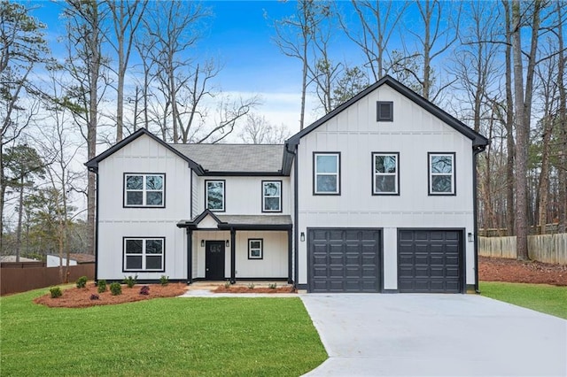 modern inspired farmhouse featuring concrete driveway, a front lawn, board and batten siding, and fence