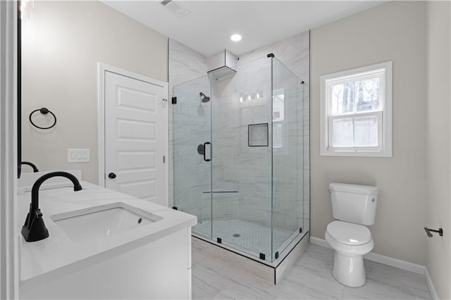 bathroom featuring toilet, a sink, visible vents, baseboards, and a shower stall