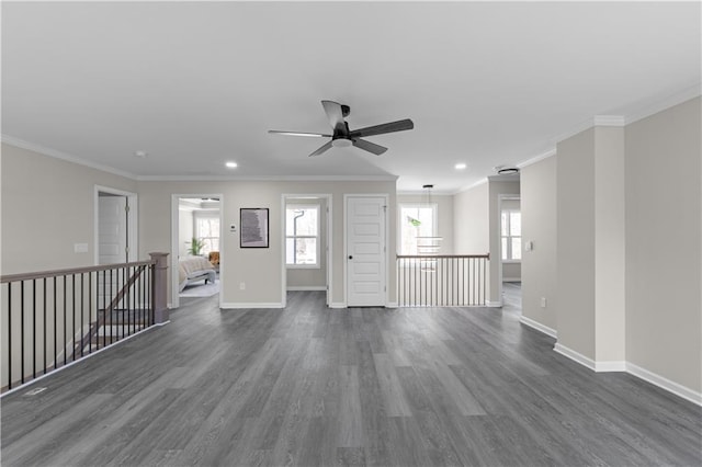 spare room featuring dark wood-style floors, plenty of natural light, and baseboards