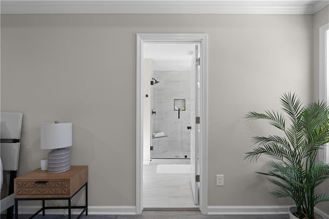 interior space with ornamental molding, wood finished floors, baseboards, and a walk in shower