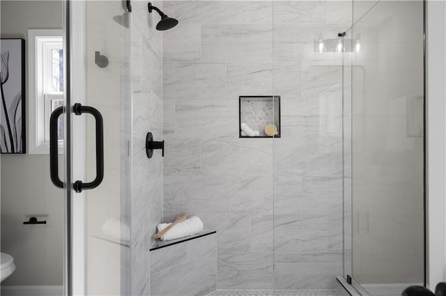 full bathroom with a shower stall and toilet